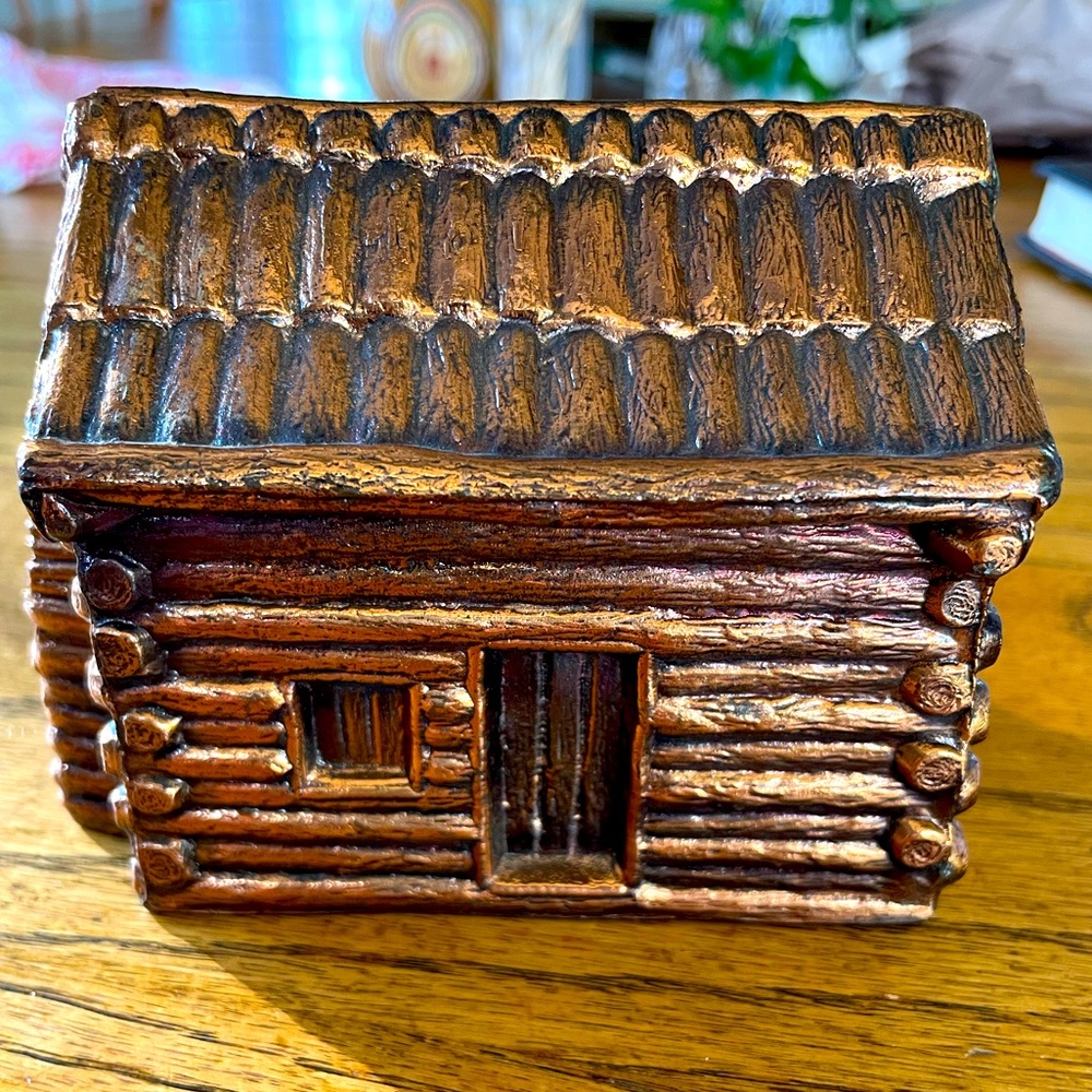 Vintage metal log cabin bank.  Dimensions @ 4.25 x 2.5 x 3.25 in inches